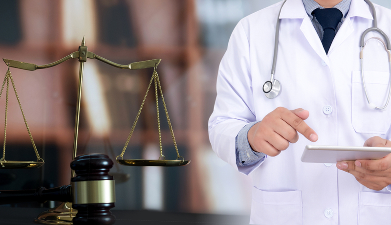 Doctor discussing medical records with a medico-legal professional